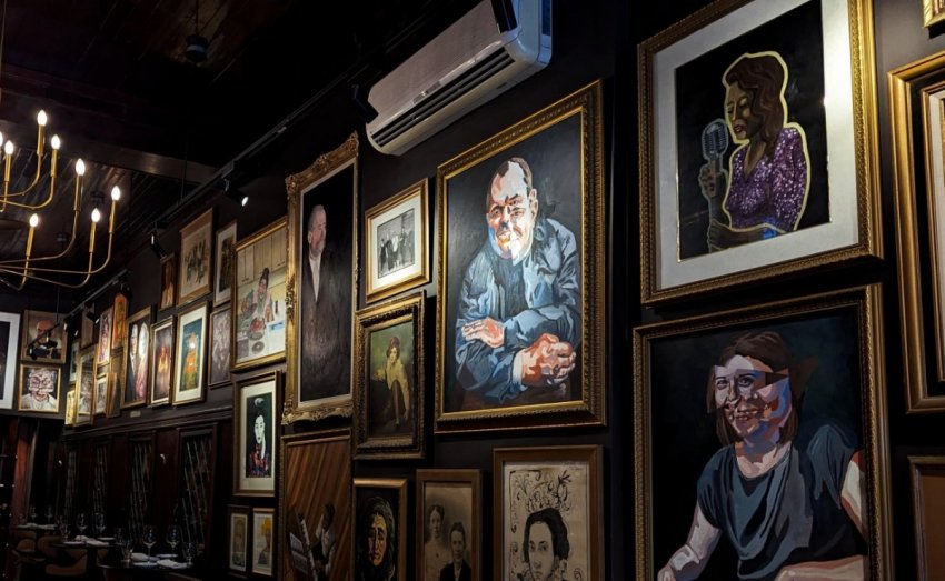 Framed portrait wall inside the dining room at Rapscallion & Co. in Hamilton.