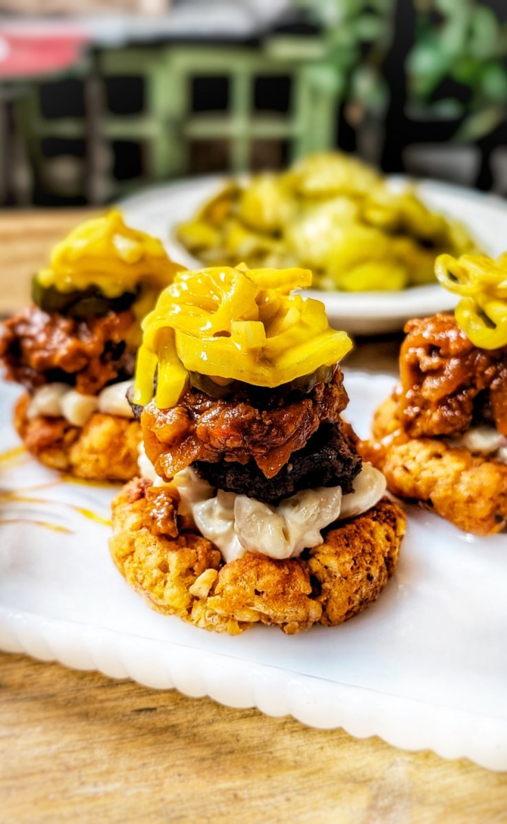 Portrait image of finished spicy Garbage Plate-inspired tater tot cups served on a platter