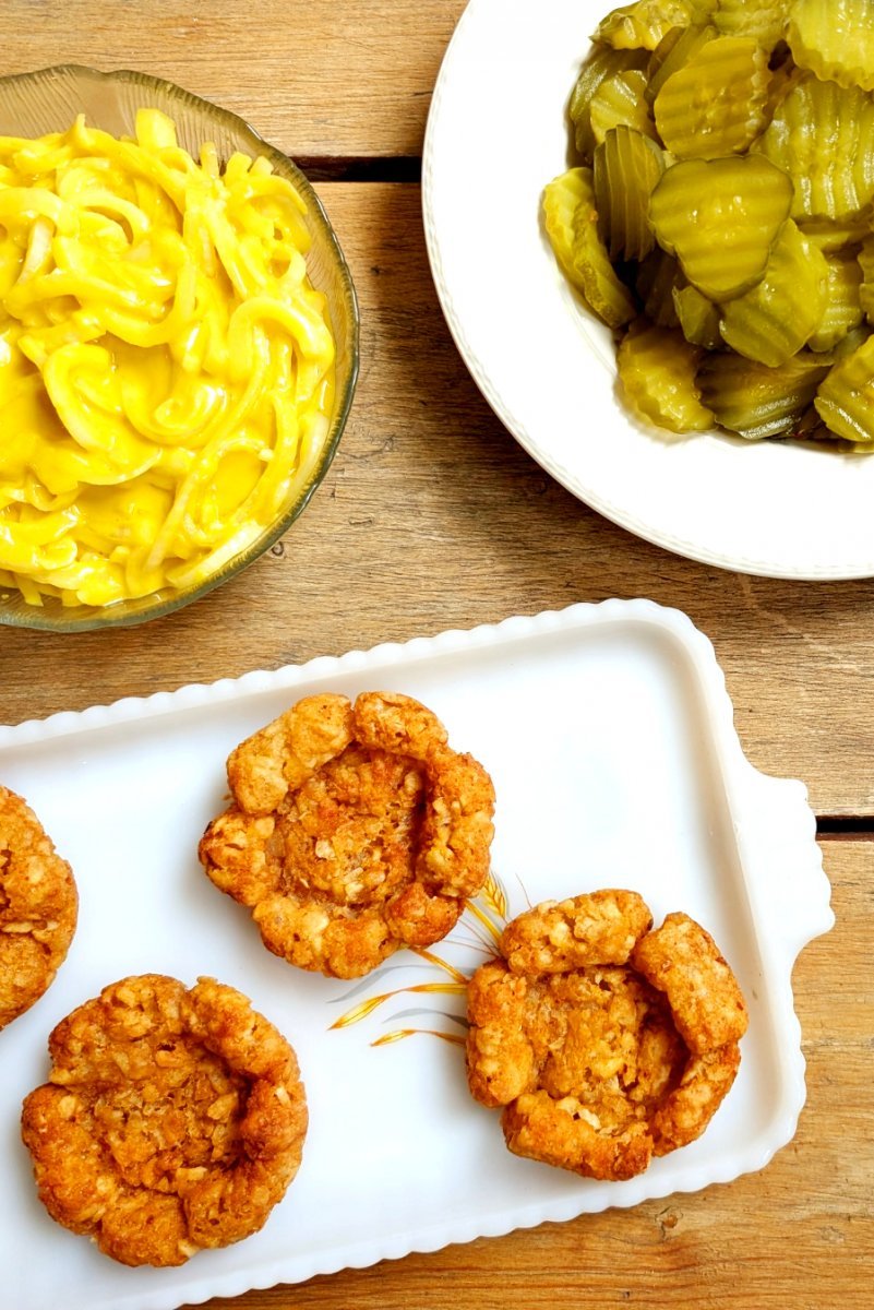 Crisp baked tater tot cups with a bowl of mustard-macerated onions for assembling the appetizer