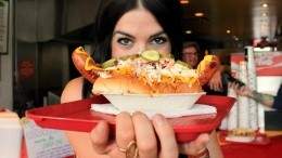 Singer Brandi Sidoryk posing inside Calgary's iconic hot dog eatery, Tubby Dog. All photos by Sam Brown. Image for In search of: Calgary's most delicious hot dogs