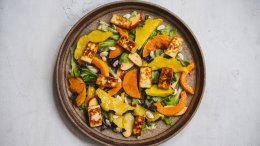 A cermaic brown plate with roast squash, greens, apple slices and grilled halloumi. A recipe from Dan Clapson's cookbook Prairie.