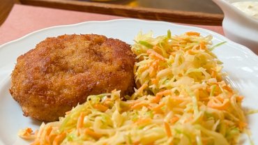 A plate of mince-meat schnitzel and coleslaw at Kantýna in Prague.