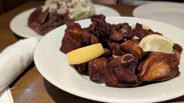 Crispy short dry ribs with lemon wedges served in the lounge at Wellington’s Steakhouse in Calgary