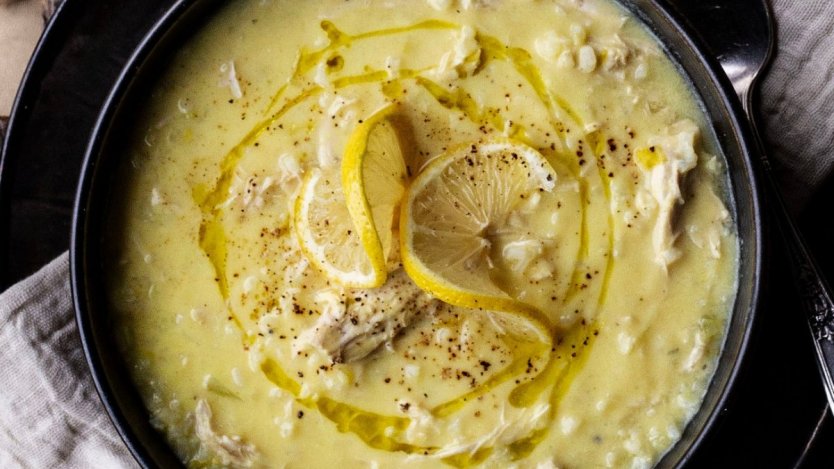 Avgolemono lemony chicken and rice soup served with olive oil and black pepper