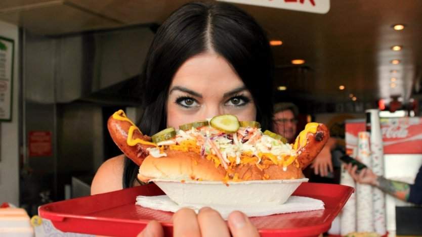 Singer Brandi Sidoryk posing inside Calgary's iconic hot dog eatery, Tubby Dog. All photos by Sam Brown. Image for In search of: Calgary's most delicious hot dogs