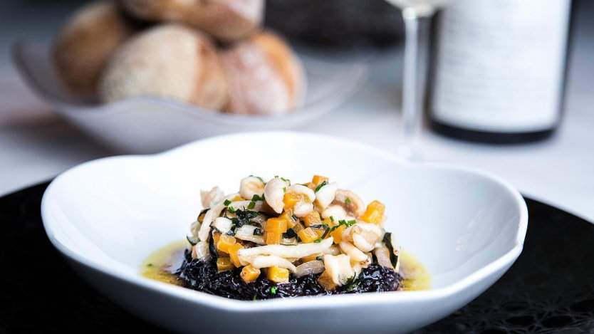 Image for Daily bite: Blue Water Cafe showcases uncommon Ocean Wise proteins in 14th annual  Unsung Heroes Festival. Black Himalayan risotto with giant red sea cucumber, pig's trotter, butternut squash and basil from 2017's Unsung Heroes Festival. Photo courtesy of Leila Likes.